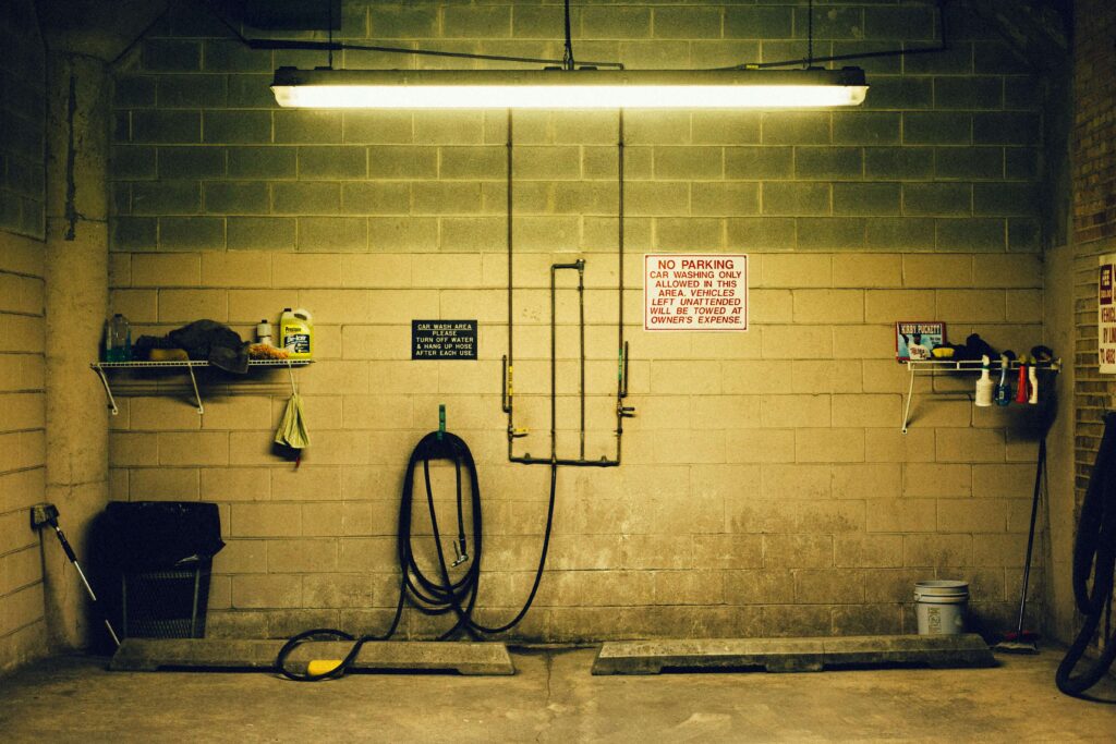 Indoor car park with coated concrete floor showing light reflectance and anti-slip texture.